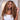 Model wearing Ali Grace #4/27 Highlight Burmese Curly Human Hair Crochet Extension featuring full volume curls, dimensional highlight color, seamless natural blend and a beautiful protective style finish.